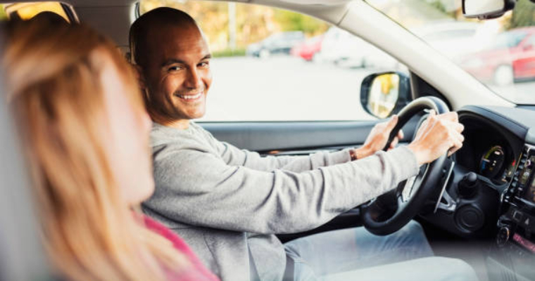 A man and a woman in a car driving