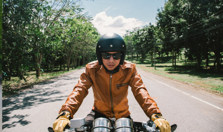 A person riding a motorcycle wearing a helmet