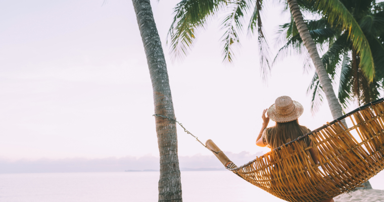 A woman in a hammock on the beach