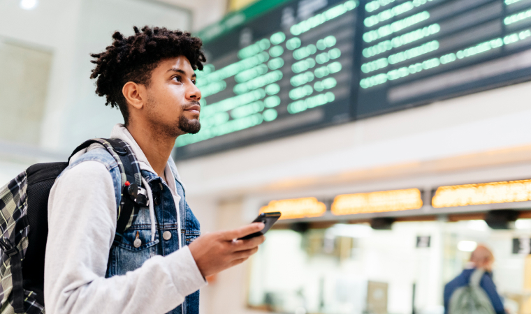 A man in the airport looking at the departure board