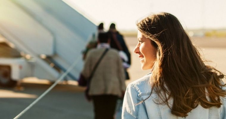 A woman boarding a plane