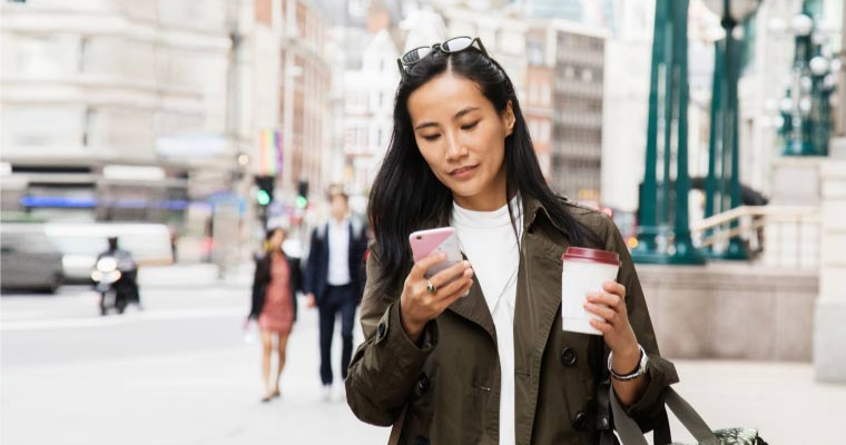 A woman on her phone in a street