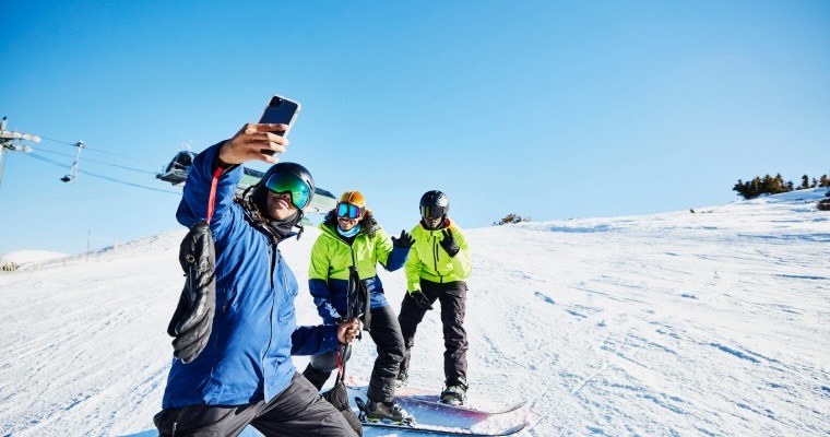 A group of people taking a selfie in the snow