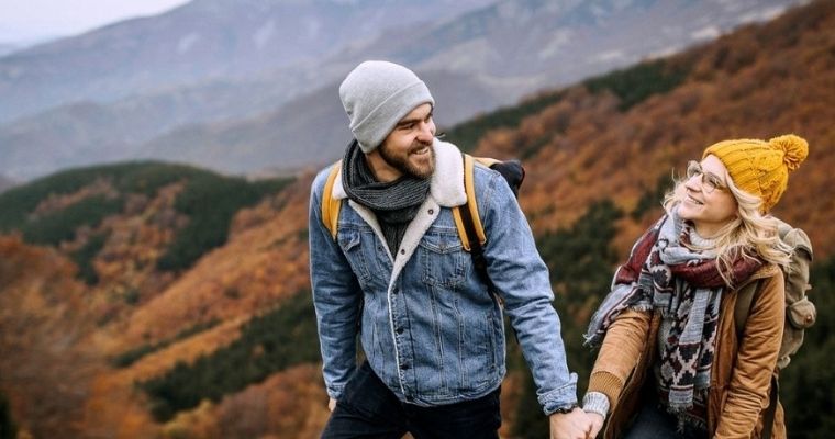 A couple hiking while holding hands in New Zealand