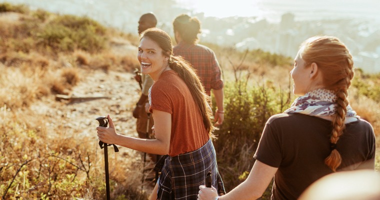 A group of people on a hike, smiling and laughing