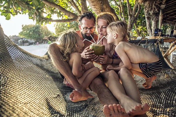 Family relaxing in hammock. 