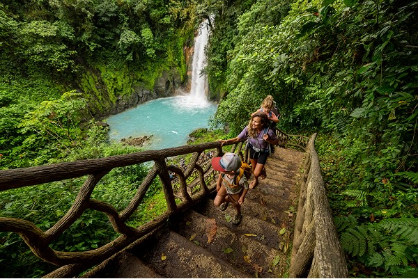 A family hiking at Rio Celeste waterfall in Costa Rica