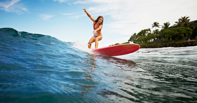 A woman surfing in Hawaii